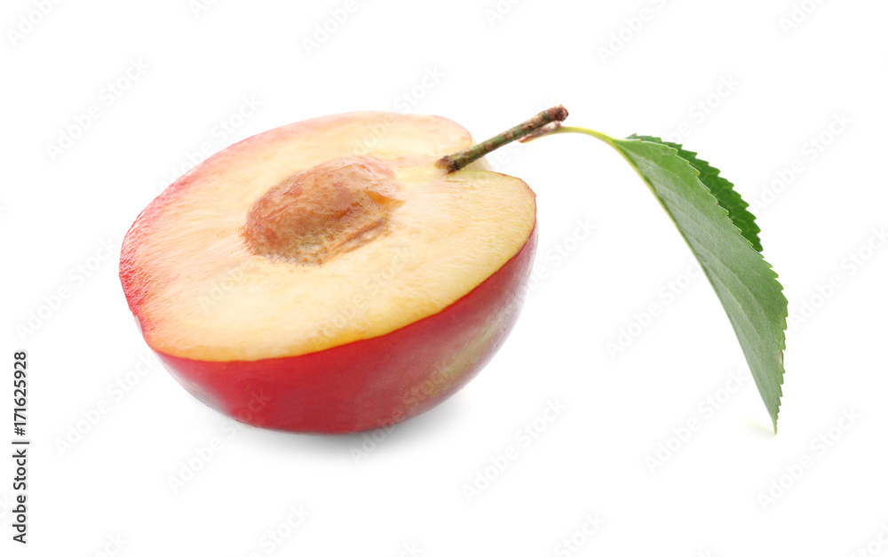 Half of fresh ripe plum on white background