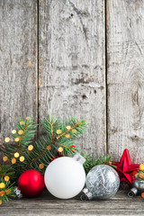 Wall Mural - red, silver and white christmas ornaments, xmas tree on rustic wood background with sparkle bokeh li