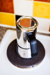 Coffee maker on a hot plate in a kitchen