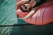 © Rachel Gulotta Photography/Stocksy - A Girl on a Swan Inflatable Floatie in a Pool in the Summer - Vibes