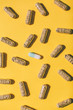 © BONNINSTUDIO/Stocksy - Bicolor pill around vitamin capsules on yellow background.