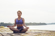 © Lumina/Stocksy - Woman exercising yoga by the river