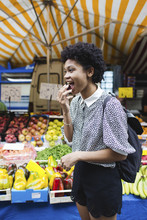 Young Woman Eats Cherries At The Marketplace