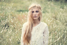 Portrait Of A Beautiful Blonde Girl In A Field
