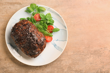 Plate with tasty baked turkey meatloaf on table