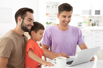 Wall Mural - Happy male gay couple with foster son at home. Adoption concept