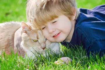 Wall Mural - Toddler boy hugging his cat