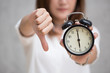 © Quality Stock Arts - Asian business woman show thumbs down with a clock time at 6 o'clock for bad time unlike delayed finish job concept