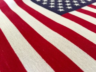 Beautifully waving star and striped American flag. American flag on wooden background. Fourth of July celebration decoration. American flag background. Red, White, Blue spirit.  American the great. 