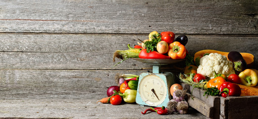 Banner composition of raw organic fresh vegetables, balance on wooden brown table