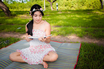 Young asian woman picnic on the meadow