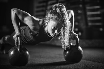 Woman athlete exercising with kettlebell