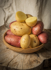 Wall Mural - fresh raw potatoes on an old table