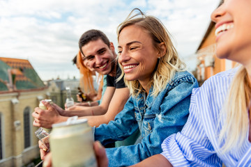 Friends on rooftop party at sunset