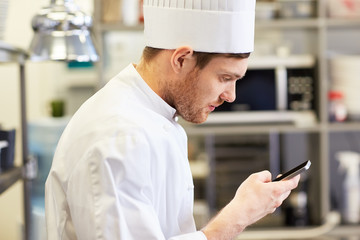 Sticker - close up of chef with smartphone at kitchen