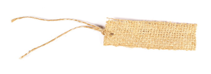 Blank textile, jute, linen tied tag isolated on white background