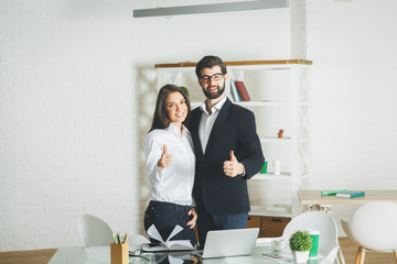 Poster - Attractive man and woman showing thumbs up