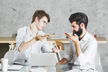 Poster - Two concentrared men working on project together