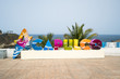 Colorful Acapulco inscription sign with bright colorful letters on a shoreline in summer sunny day