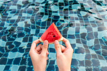 two woman hands holding a piece of watermelon