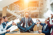 canvas print picture - young handsome business man in black suit practice yoga and relax at office