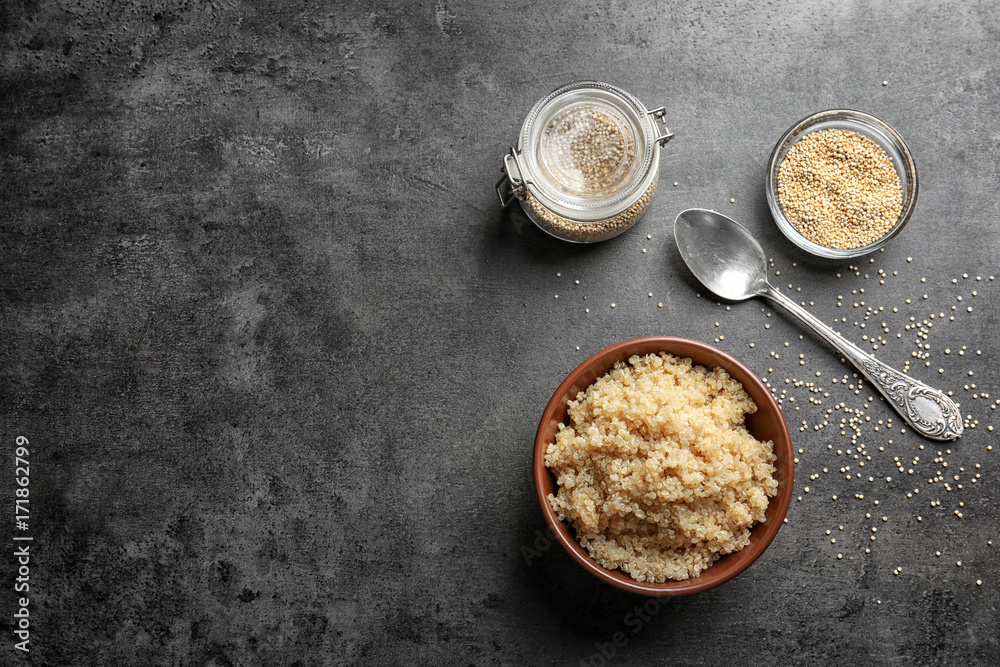Bowl with boiled white quinoa grains on kitchen table