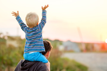 Wall Mural - Father and son outdoor portrait in sunset sunlight