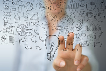 Leinwandbilder - Businesswoman touching and holding sketch lightbulb