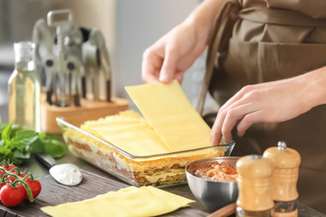 Sticker - Woman preparing meat lasagna in kitchen