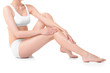 © Africa Studio - Young woman touching her leg on white background