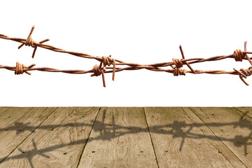 Old wooden panel and rusty barbed wire isolated on white background.