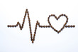Cardiogram and heart drawn with coffee beans