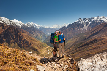 Wall Mural - couple is posing to the camera in front of manaslu valley in highlands of himalayas