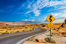 Road Sign For Curves In Desert