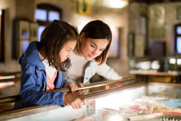 Wall Mural - Mother and daughter pointing at sight during