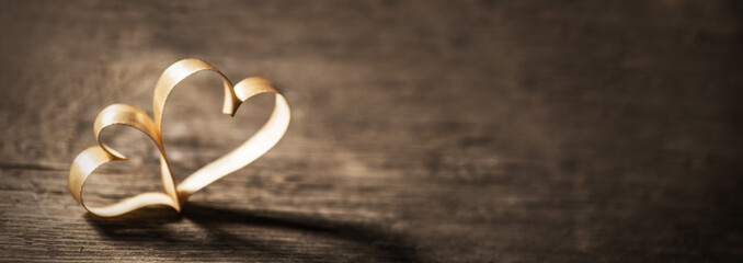 Two ribbon hearts on wood