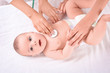 © Africa Studio - Doctor examining baby with stethoscope at home