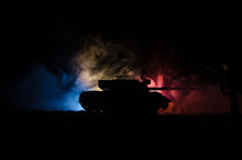 War Concept. Military Silhouettes Fighting Scene On War Fog Sky Background, German Tank In Action Below Cloudy Skyline At Night. Attack Scene. Armored Vehicles