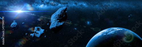 a swarm of asteroids moving towards planet Earth in front of the Milky Way galaxy