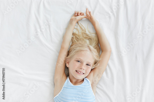 Indoor Shot Of Adorable Female Little Child With Blue Eyes Blonde