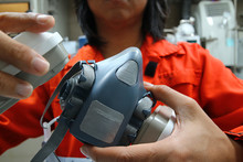 Multi-purpose respirator half mask for toxic gas protection.The man prepare to wear Multi-purpose respirator half mask.
