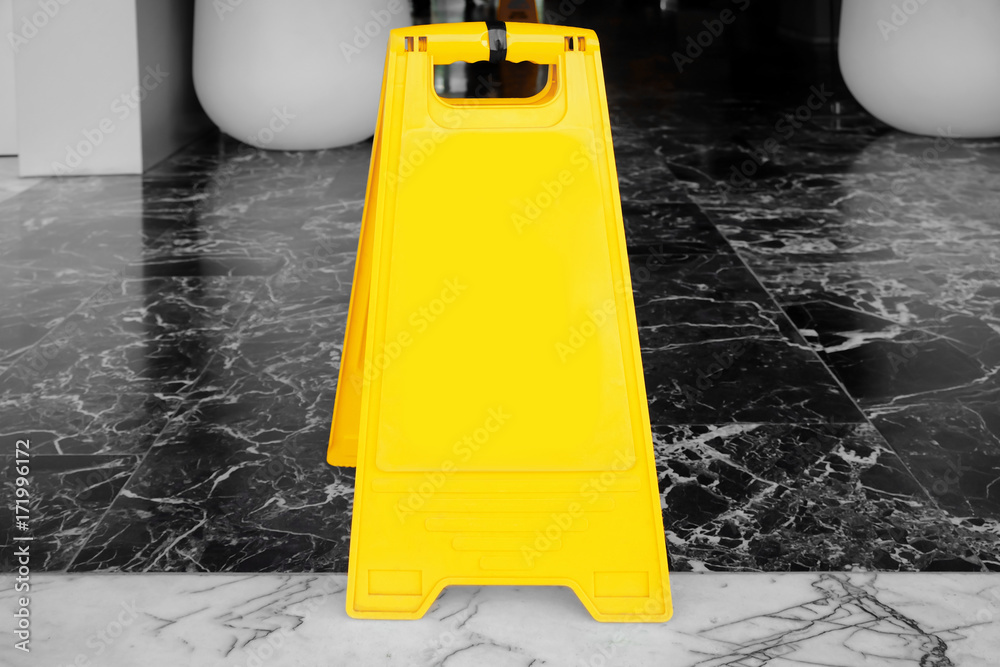 Yellow sign for advertisement on floor