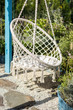 © Andrii Zastrozhnov - Cozy place to relax in the garden, white rope chair.
