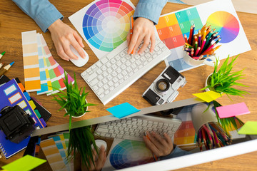 Wall Mural - Young cute Graphic designer using graphics tablet to do his work at desk