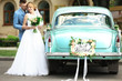 © Africa Studio - Happy wedding couple near decorated car, outdoors