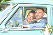 © Africa Studio - Happy wedding couple in car