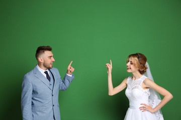 Wall Mural - Happy wedding couple on color background
