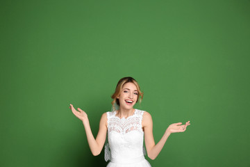 Wall Mural - Young beautiful bride on color background