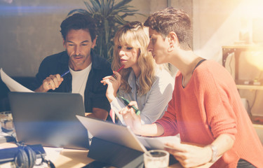 Wall Mural - Group of coworkers making great conversation during work process in modern office.Business people meeting concept.Blurred background.Horizontal.