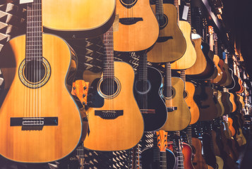 Many Classical Guitars Hanging on Wall in the Shop